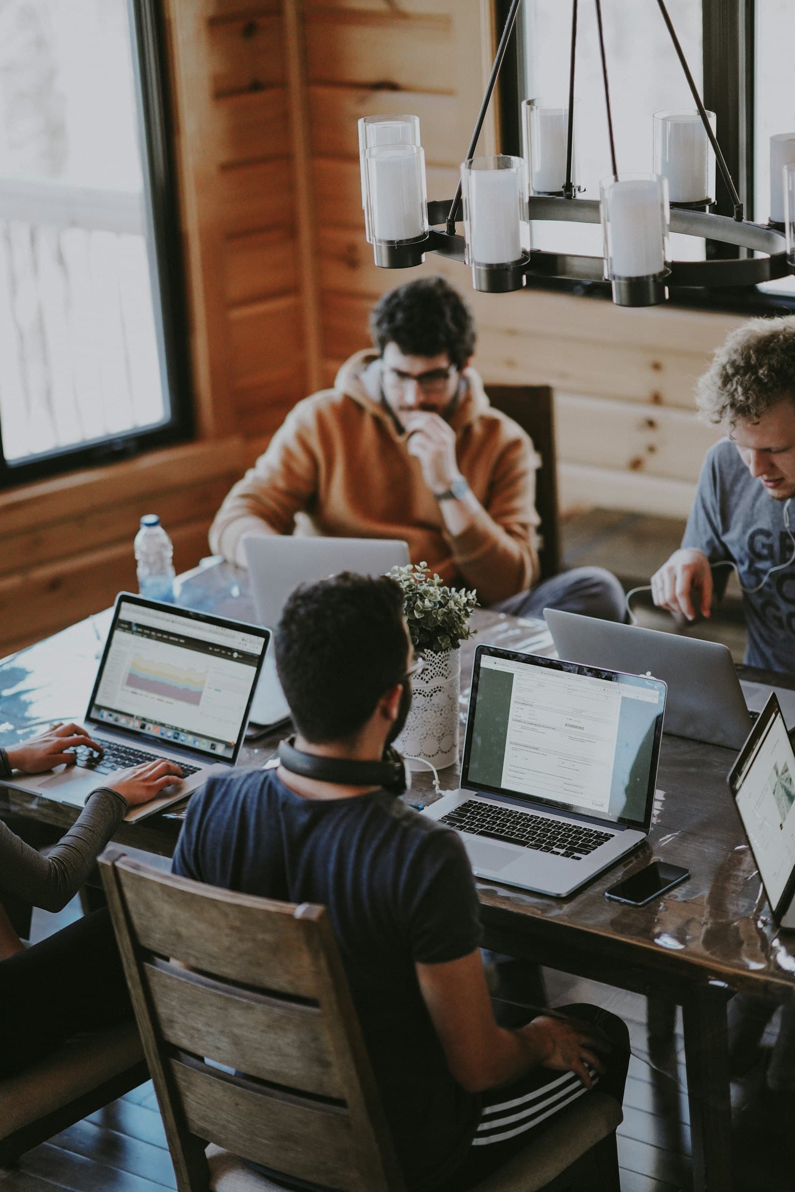 Technology professionals collaborating around a shared screen